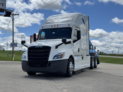 Conventional sleeper truck front-left view of a white 2021 Freightliner Cascadia 126 with high sleeper cab, black grille, and large mirrors.
