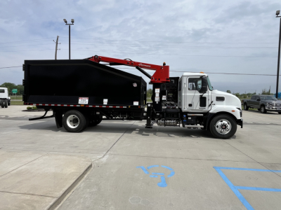 Mack MD7 truck with a black dump body and red crane arm, side profile view showing grapple/boom equipment, white cab, VIN 1M2MDBAB3SS077353, stock 67576.