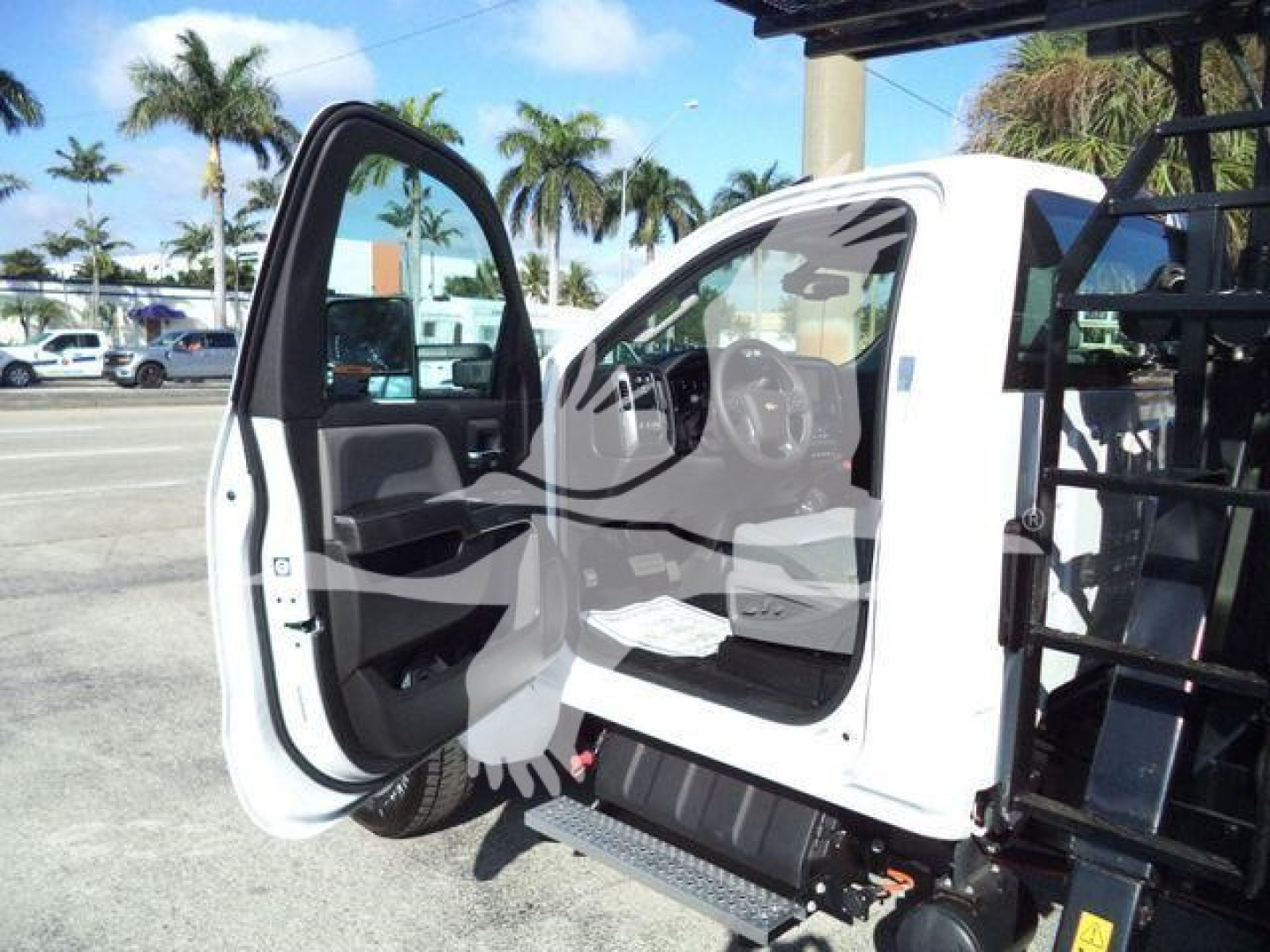 Truck cab with front door open showing interior of a 2023 Chevrolet Silverado 6500HD chassis cab.