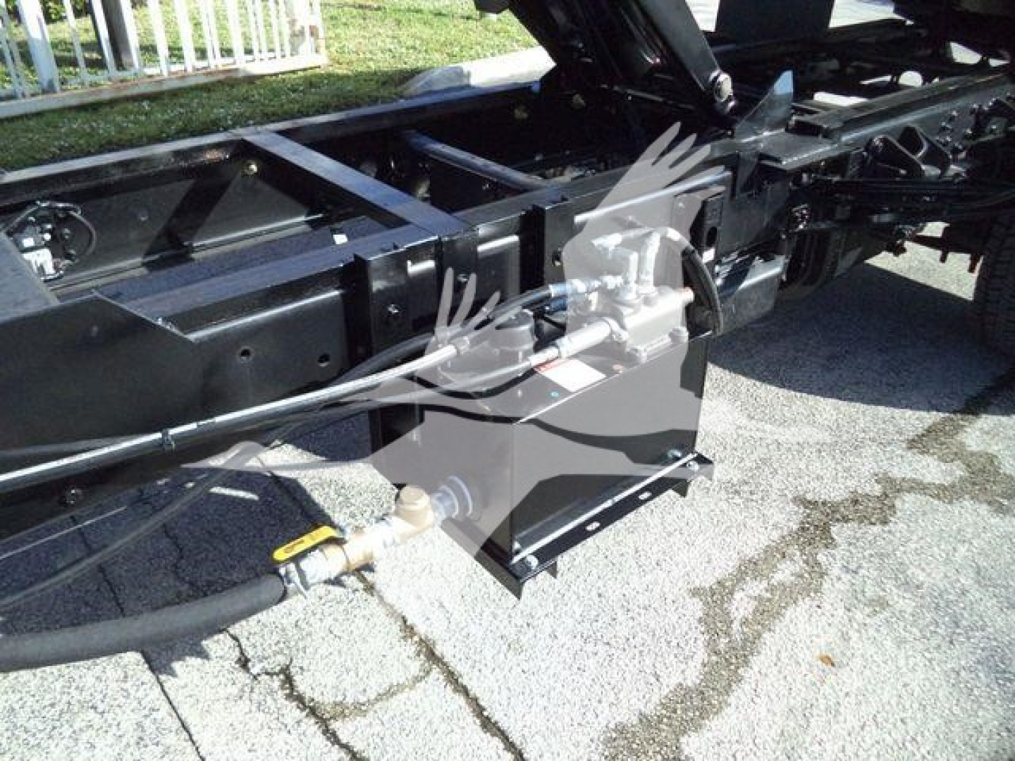 Truck chassis frame with hydraulic lines and a yellow-handled valve on a Silverado 6500HD chassis