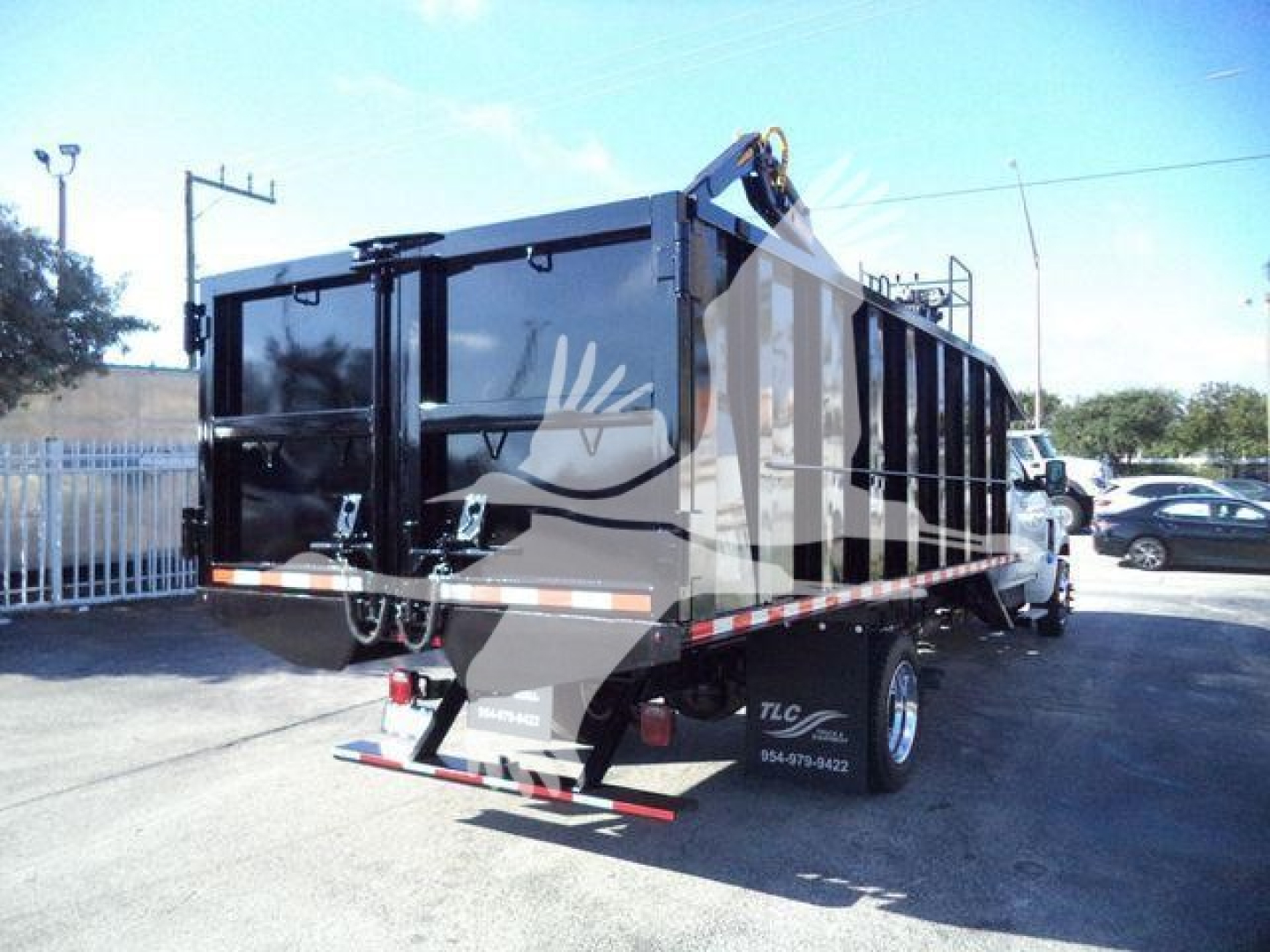 Truck bed/dump trailer on a Chevrolet Silverado 6500HD chassis showing rear view with black dump bed and taillights.