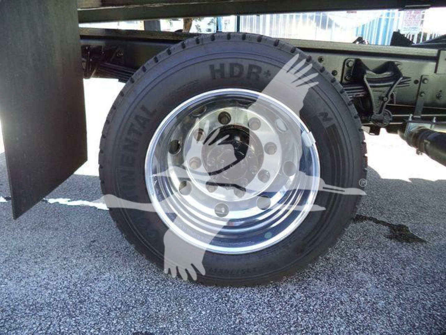 Wheel and tire close-up on a 2023 Chevrolet Silverado 6500HD chassis showing steel rim and tire with 'Continental' branded sidewall and surrounding undercarriage components.