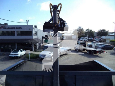 Front view of a 2023 Chevrolet Silverado 6500HD in a dealership lot with a head-on crane attachment visible in foreground