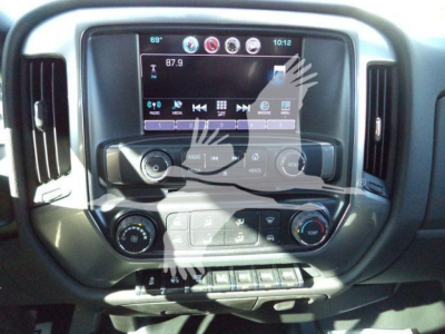 Dashboard of a 2023 Chevrolet Silverado 6500HD showing touchscreen infotainment system and control knobs.