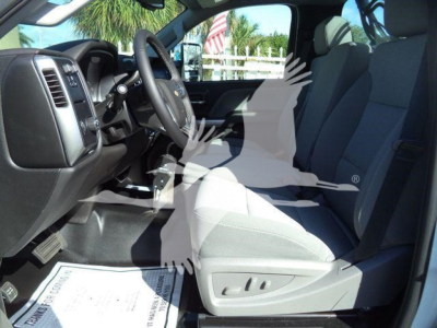 Interior view of a 2023 Chevrolet Silverado 6500HD cab with front seats and dashboard; steering wheel visible.