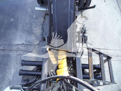Truck chassis and suspension components of a 2023 Chevrolet Silverado 6500HD seen from above, with yellow coil suspension and black tubular frame.