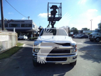 Chevrolet Silverado 6500HD truck front view with lift bucket on top, dealership lot in background