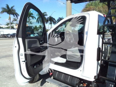 Truck cab interior with front passenger door open, showing Chevrolet Silverado 6500HD interior and entry step.