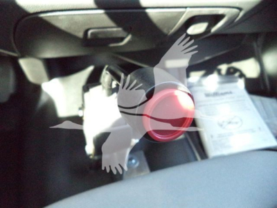 Chevrolet Silverado 6500HD interior view showing a red ignition button and dashboard area.