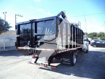 Truck bed/dump trailer on a Chevrolet Silverado 6500HD chassis showing rear view with black dump bed and taillights.