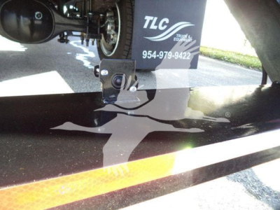 Truck trailer showing camera and TLC branding with a Silverado 6500HD listing in inventory.