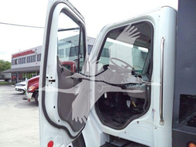 Truck cab open door of Freightliner Business Class M2 106 rollback showing interior dashboard and door frame with side mirror.