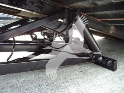 Truck undercarriage showing towing equipment and frame components of a 2006 Freightliner Business Class M2 106 rollback.
