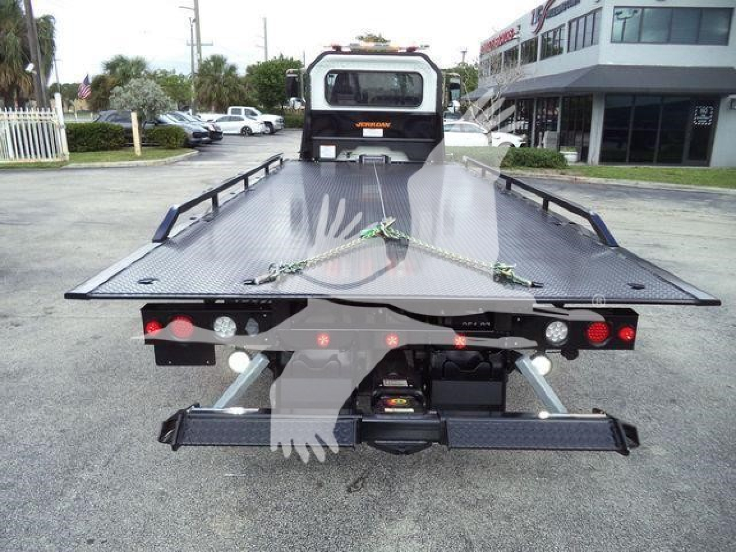 Peterbilt 337 rollback tow truck rear view showing flatbed with loading ramps and hydraulic winch system.