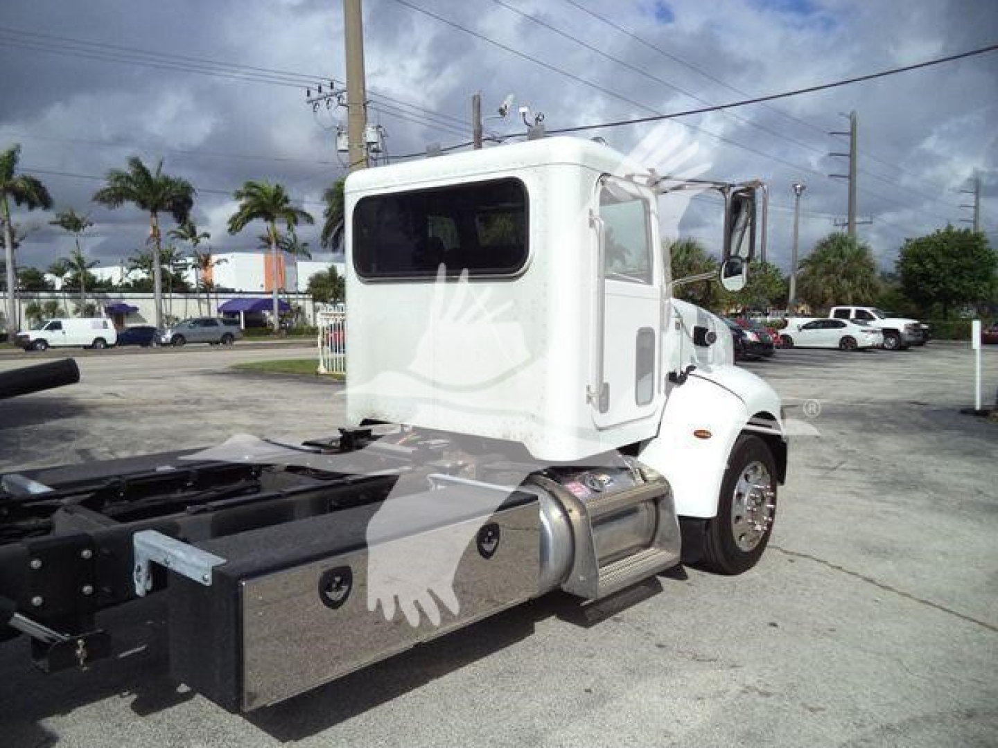 Peterbilt 337 rollback truck cab with white exterior and metal chassis, side view showing fuel tank and rear hitch.