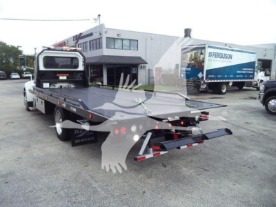 2019 Peterbilt 337 rollback tow truck rear view showing tow bed and rear lighting.