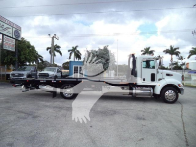 2019 Peterbilt 337 rollback truck shown in side view with extended flatbed and wheel-lift mechanism.