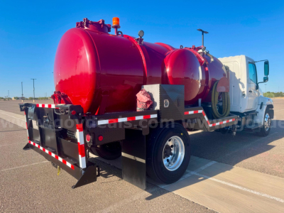 Vacuum tank truck with red cylindrical tanks mounted on a white cab chassis viewed from rear-left, stock number 24329-523.