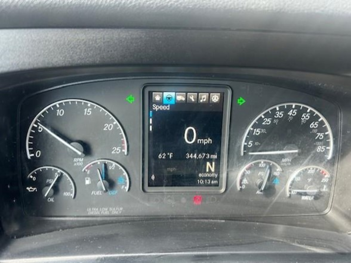 Dashboard of a 2022 Freightliner Cascadia 116 showing digital screen with Speed 0 mph and gauges on left and right.