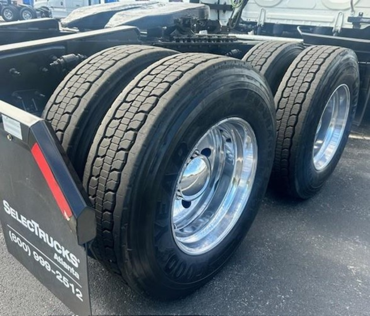Freightliner Cascadia 116 truck rear dual rear tires and wheel rims visible in a used truck listing.