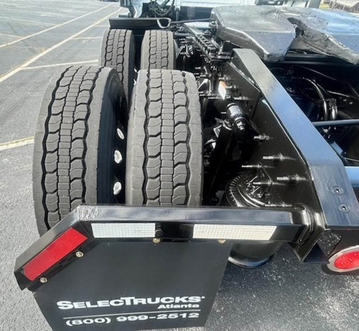 Truck rear view showing dual rear axles and chassis undercarriage; single tag reads SELECTRACTS Atlant at (800) 000-2612