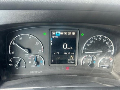 Dashboard of a 2022 Freightliner Cascadia 116 showing digital screen with Speed 0 mph and gauges on left and right.