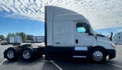 Freightliner Cascadia 116 side view showing sleeper cab and chassis with dual rear axles.