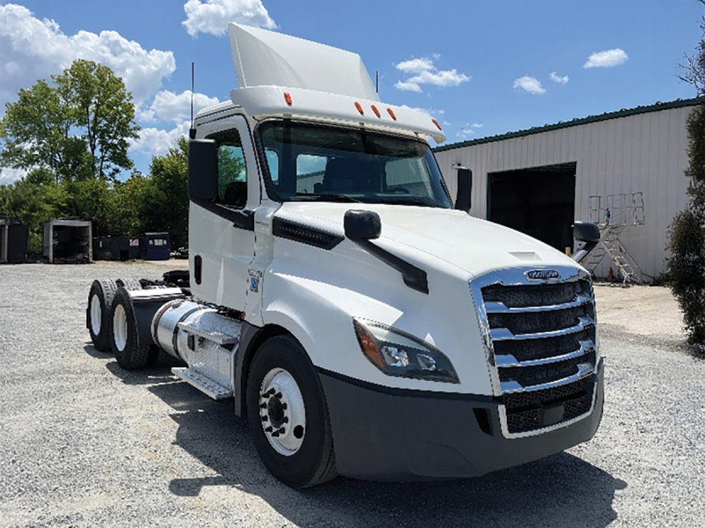 Freightliner Cascadia 126 daycab truck front-left view showing chrome grille and white cab