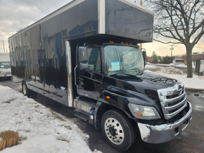 Truck side view showing 2020 Hino 268A box truck in black with cargo box and cab, VIN 5PVNJ8JV1L5S78344.