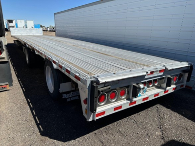 Rear of 2018 Reitnouer all aluminum drop deck trailer showing dual rear axles, aluminum deck, and rear lights; VIN plate and stock area not visible.