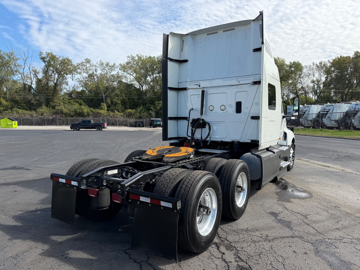 Truck cab of a 2021 International LT625 tractor from rear-right angle showing fifth-wheel area and dual rear axles with mud flaps.