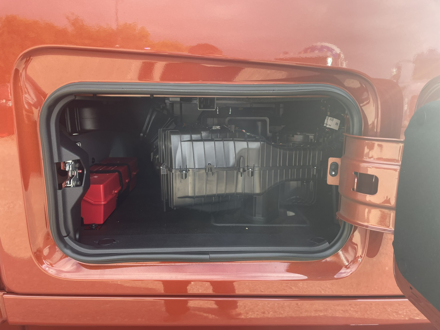 Volvo VNL64T860 fuel/electrical bay open showing battery box and power components inside front compartment