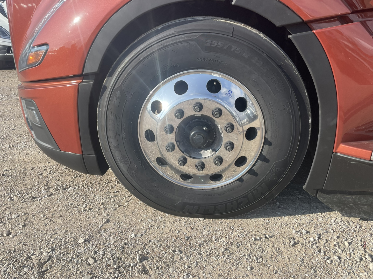 Volvo VNL64T860 front wheel showing chrome hub with lug nuts and tire sidewall details.