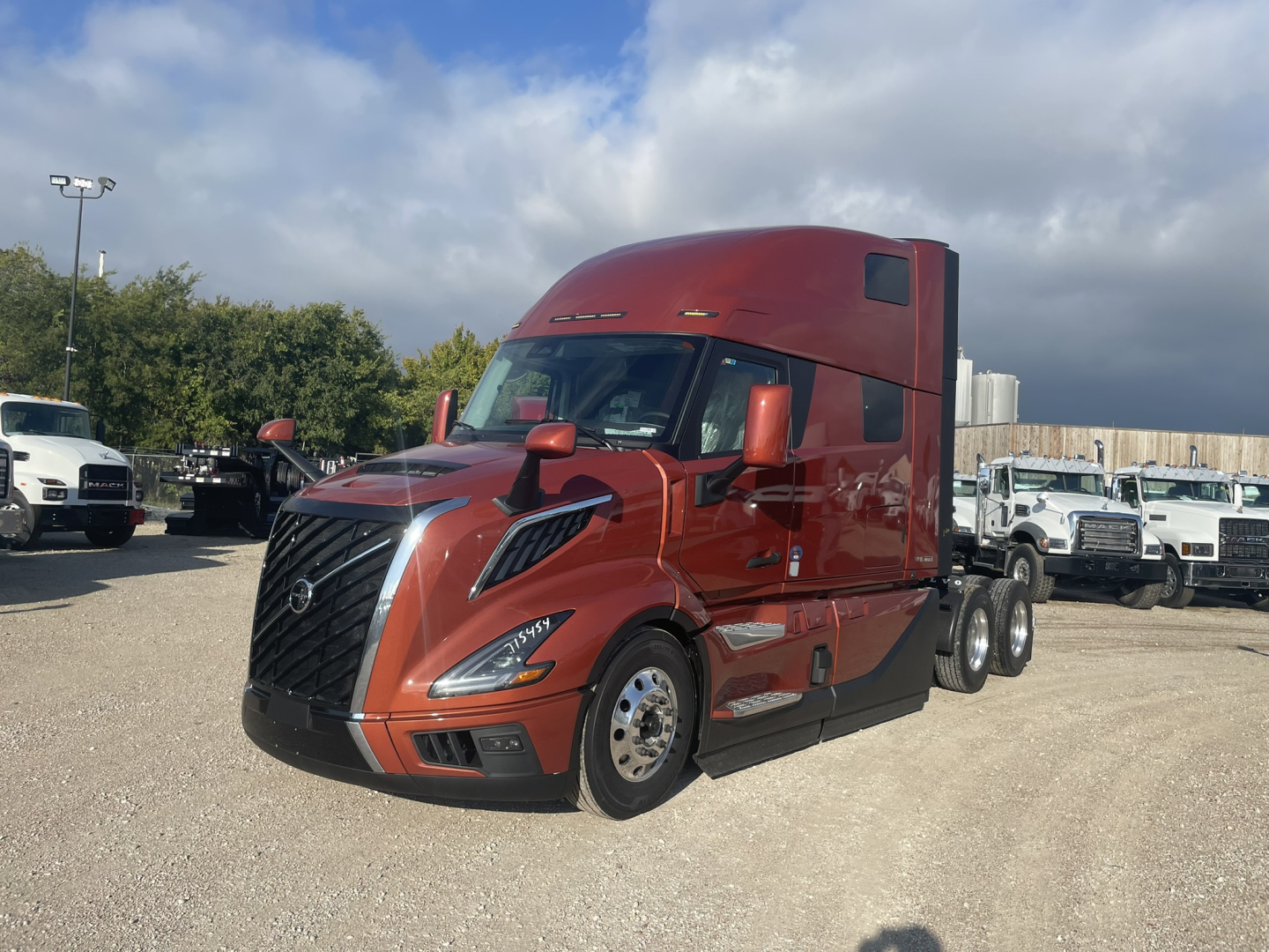 Volvo VNL64T860 semi-truck in red/orange color profile view showing sleeper cab and aerodynamic fenders.