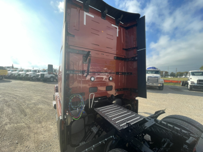 Volvo VNL64T860 cab rear view showing hitch area and wiring harnesses with exposed fifth-wheel area and ladder rungs