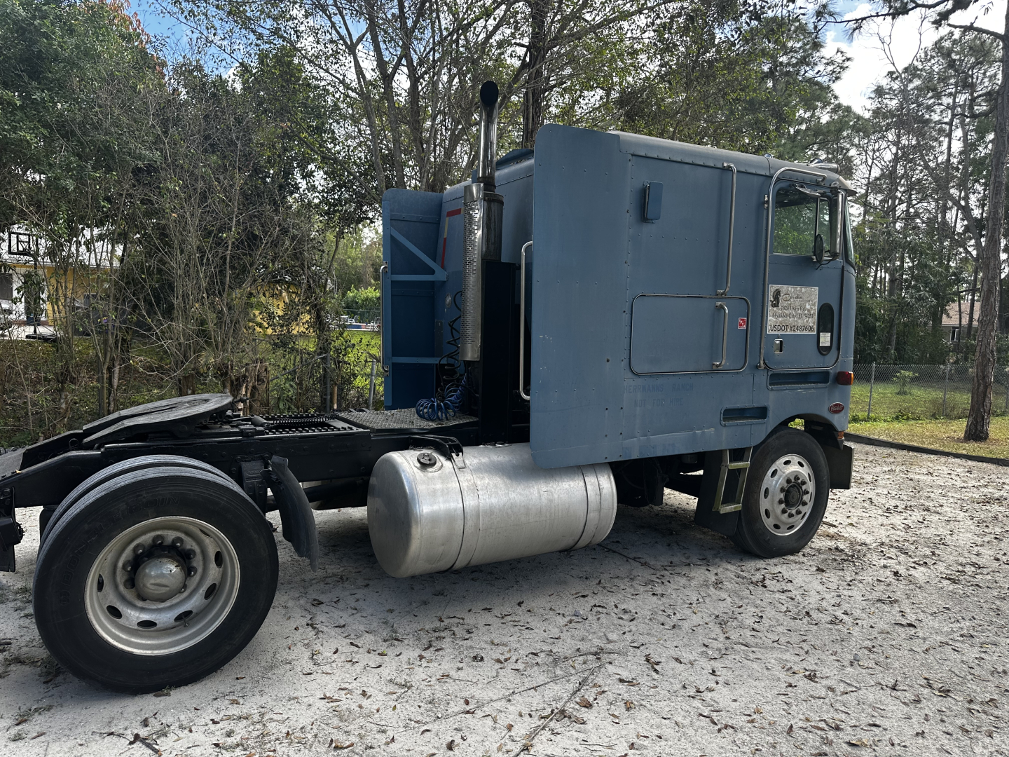 Peterbilt 362 cabover truck side view showing fuel tank and rear chassis with cab mounted, light blue paint, no visible branding text.