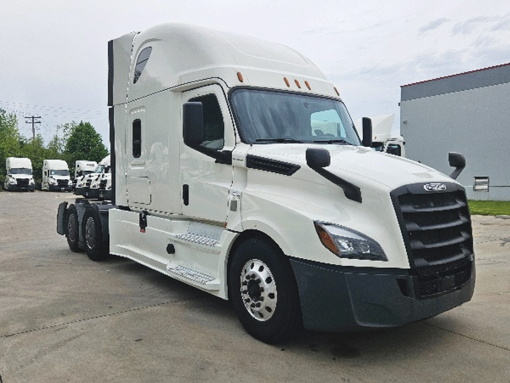 Freightliner Cascadia126 tractor-trailer cab in white, side view showing sleeper cabin and front grille.