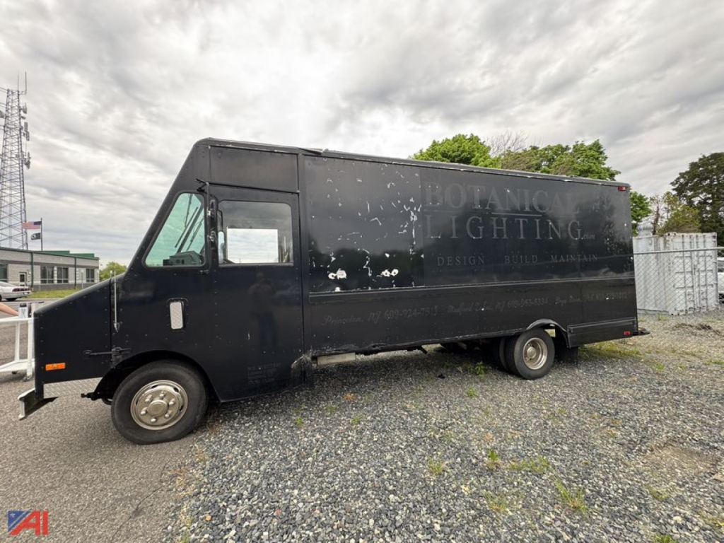 Isuzu NPR box truck in a black cargo body showing side view with faded logo and loading area.