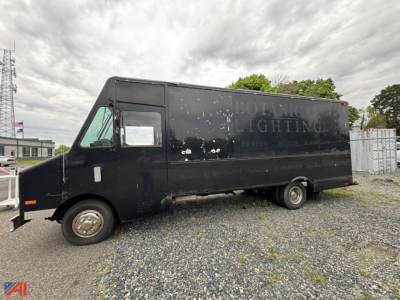 Isuzu NPR box truck in a black cargo body showing side view with faded logo and loading area.