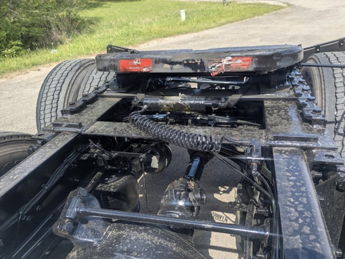 Freightliner Cascadia 126 truck chassis view showing undercarriage, drive shaft, rear suspension, and fifth wheel mount.