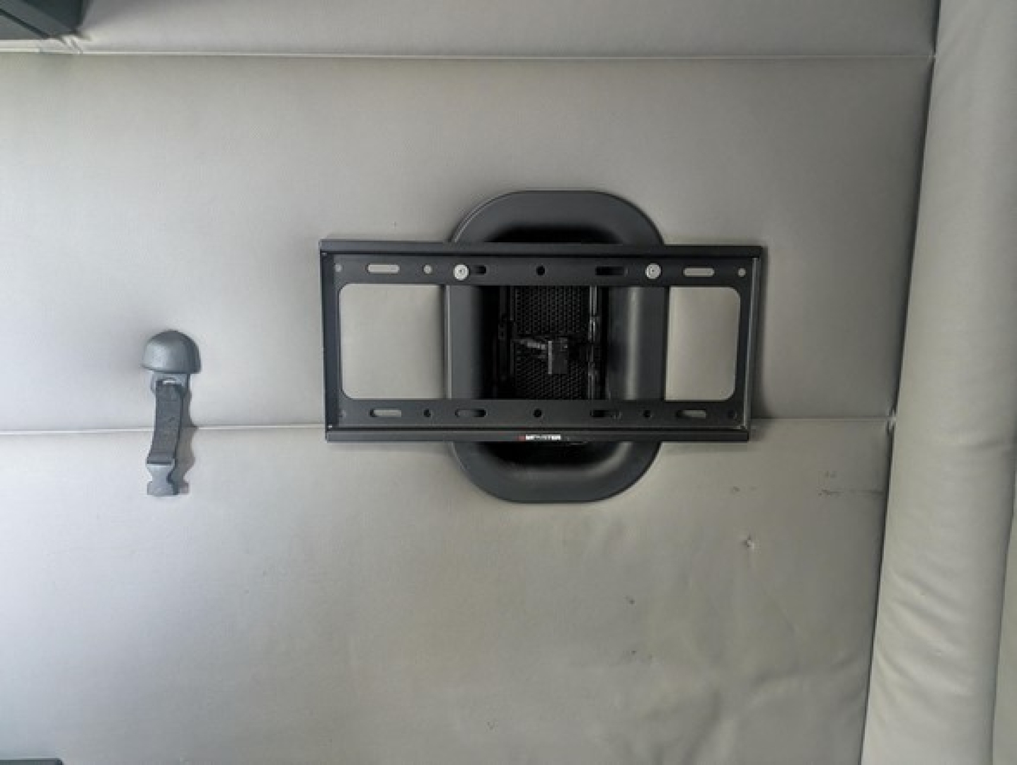 Freightliner Cascadia interior showing seatback or sleeper area with a recessed mount and a bracket plate.