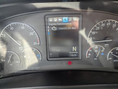 Dashboard display of a 2022 Freightliner Cascadia 126 showing engine maintenance screen and speedometer gauges.
