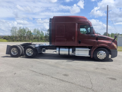 Freightliner Cascadia 126 sleeper cab tractor side view showing fuel tanks and rear axle group.