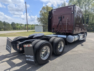 Freightliner Cascadia 126 tractor rear and chassis showing dual rear axles, maroon sleeper cab, fuel tanks, and mud flaps with SelectTrucks branding.
