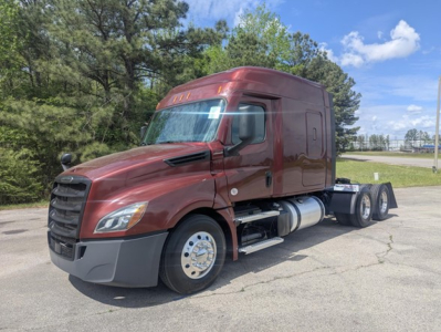 Freightliner Cascadia 126 truck in maroon with sleeper cab, side view showing dual rear axles and fuel tanks.