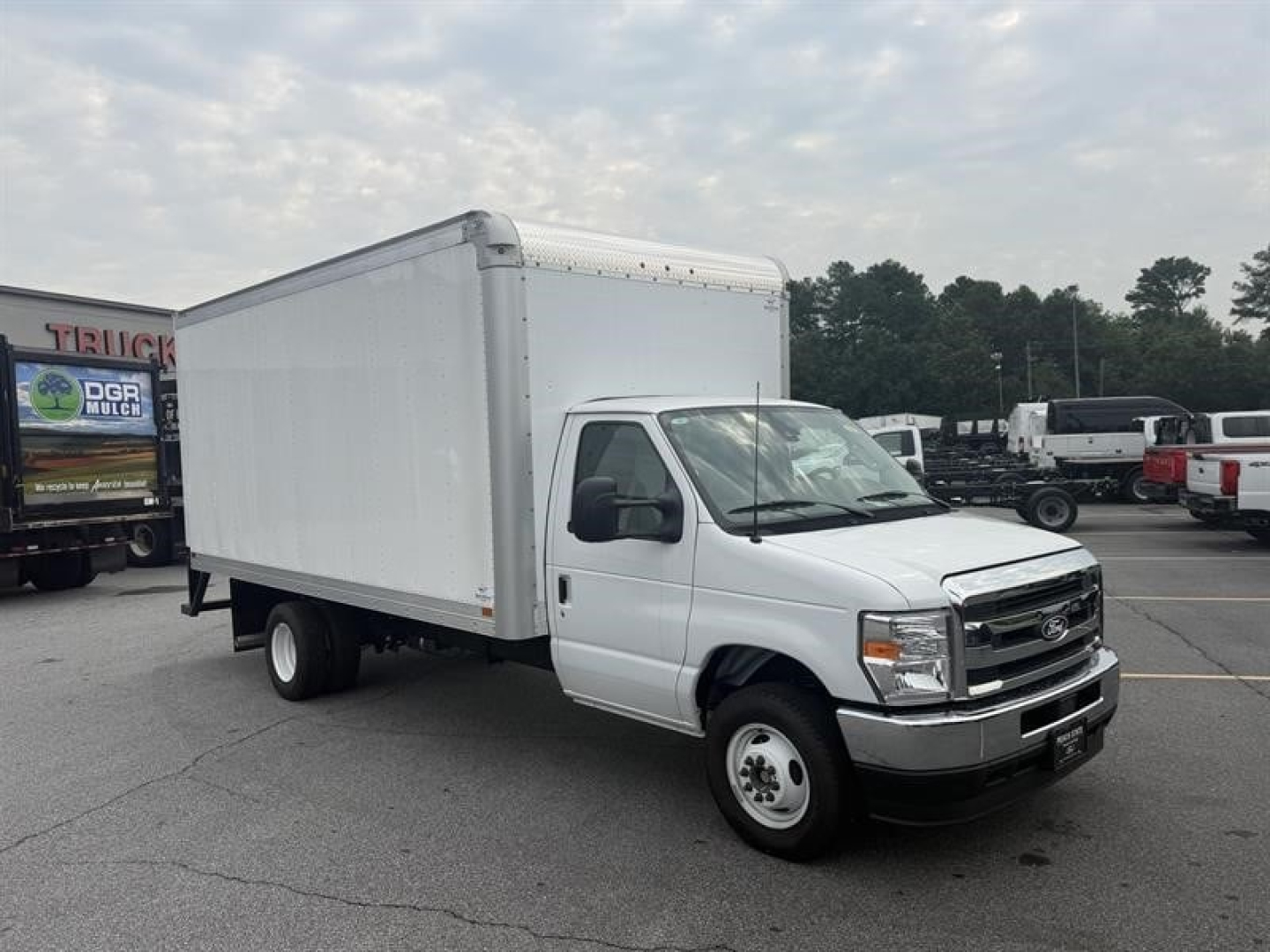 Ford E-450 box truck with a large cargo box in a dealership lot.