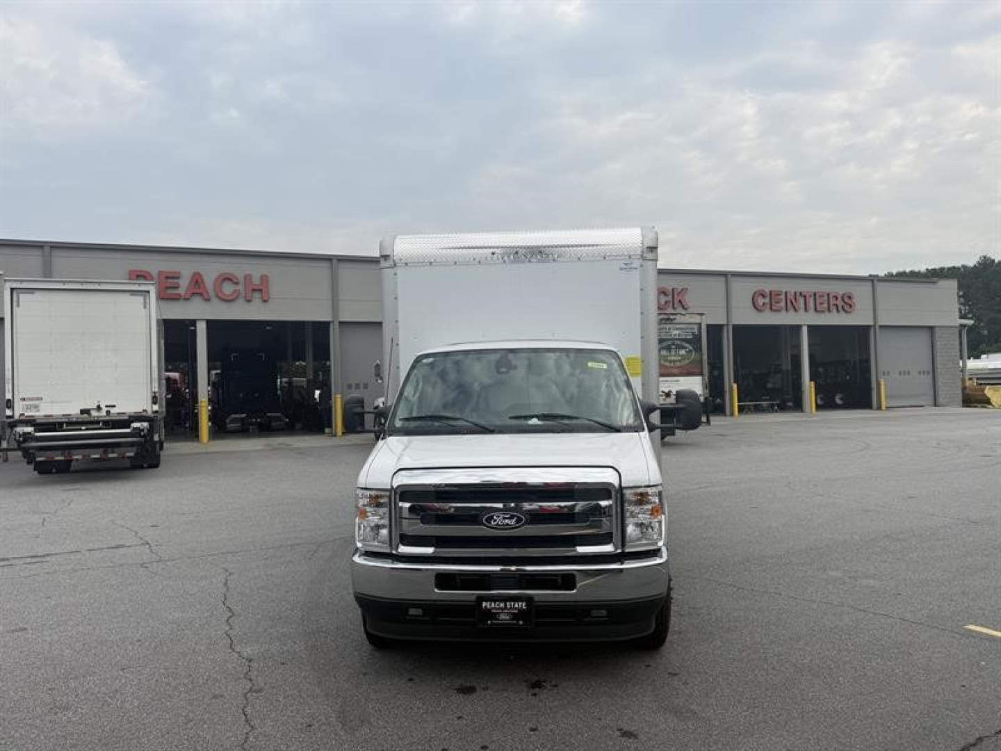 Ford E-450 box truck front view showing grille and bumper in dealership lot