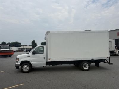 White 2027 Ford E450 box truck in a parking lot, side view showing cargo box and cab; no visible brand decals on the box.
