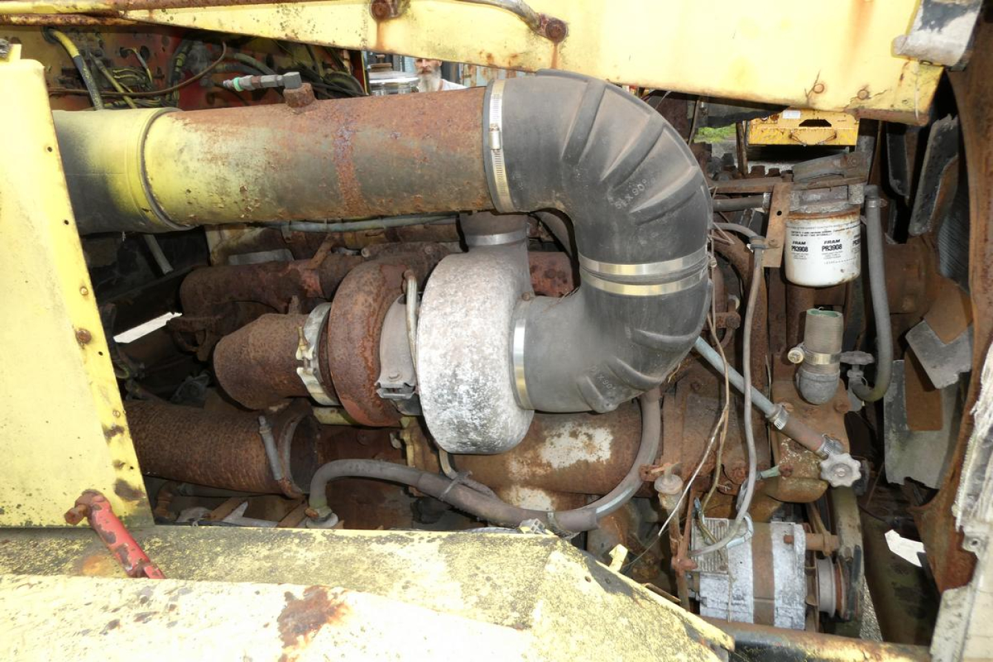 Engine bay of 1973 Autocar CAB CUT showing turbocharger with large curved intake hose and surrounding mechanical components.