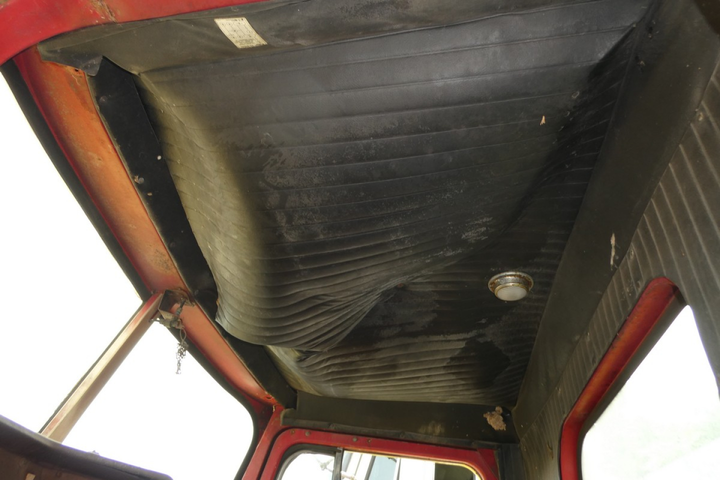  cabin interior of a 1973 Autocar day cab showing roof and ceiling with ribbed panels and sun visor